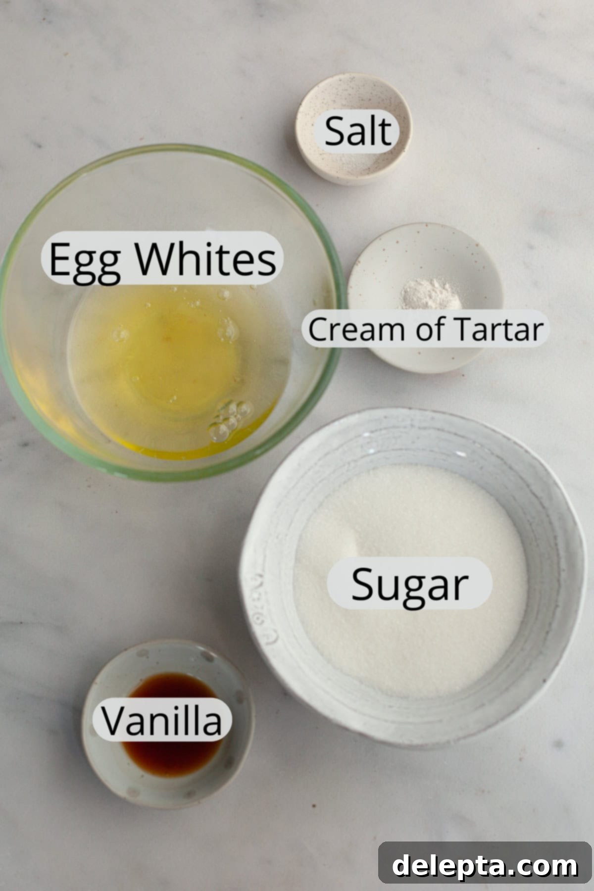 Fluffy Marshmallow Meringue Frosting 3 All the essential ingredients for homemade marshmallow meringue frosting, meticulously weighed out and arranged in small bowls, signifying readiness for preparation.