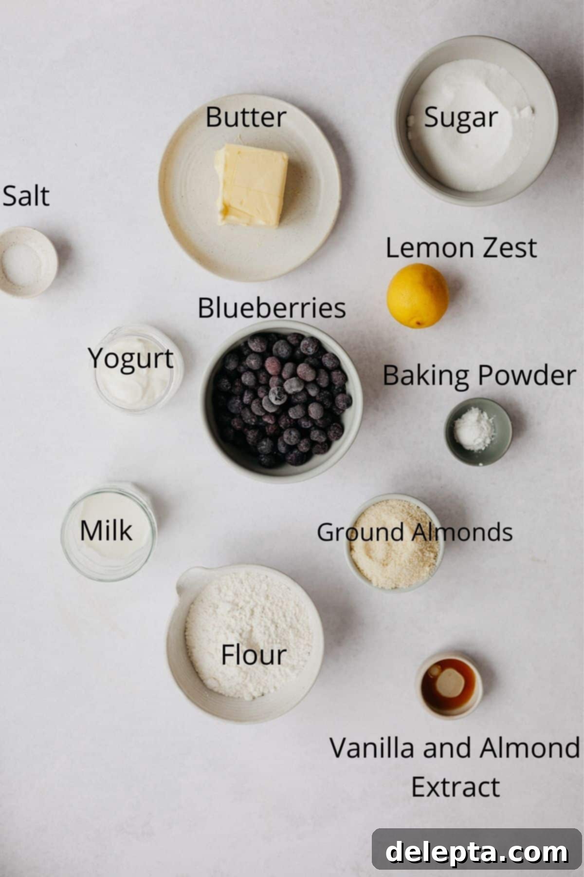 Sun-Kissed Blueberry Almond Lemon Cake 4 An overhead shot of all the dry and wet ingredients needed for a blueberry cake laid out on a counter.