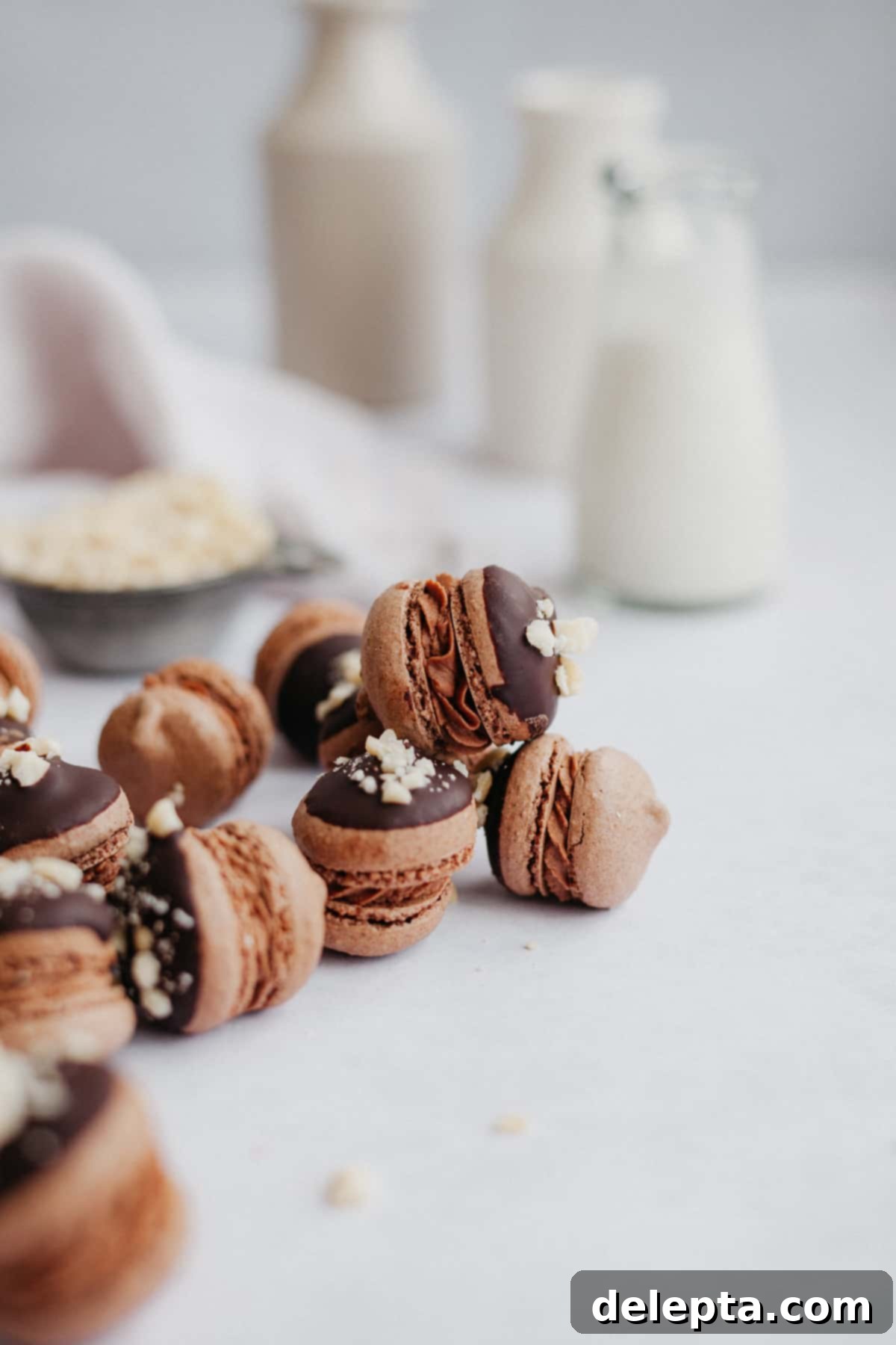 Decadent Nutella Macarons 3 Six perfectly arranged Nutella macarons on a elegant marble counter with a small milk jug in the background