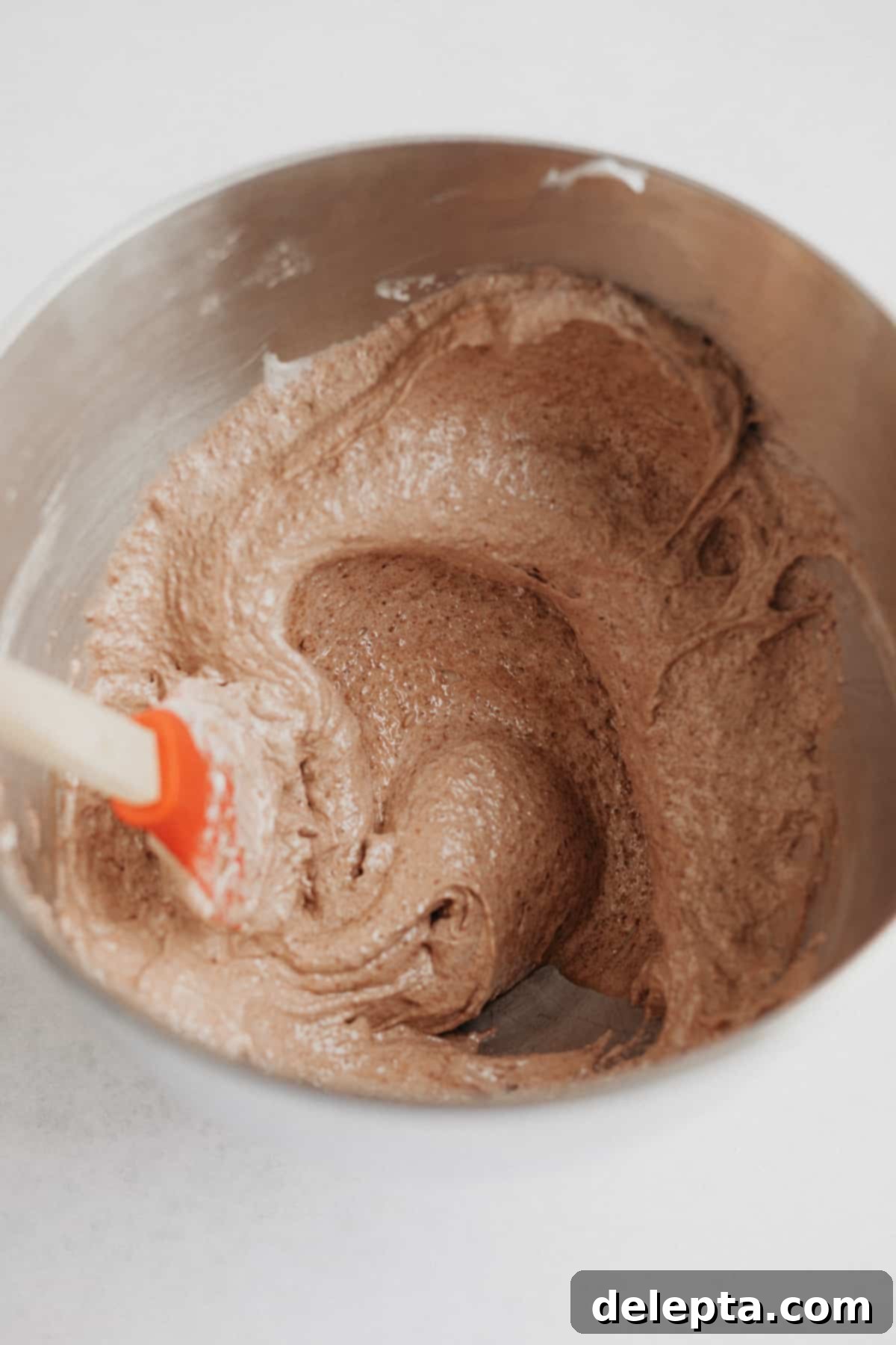 Decadent Nutella Macarons 8 Smooth, glossy Nutella macaron batter in a large silver bowl, perfectly macaronaged
