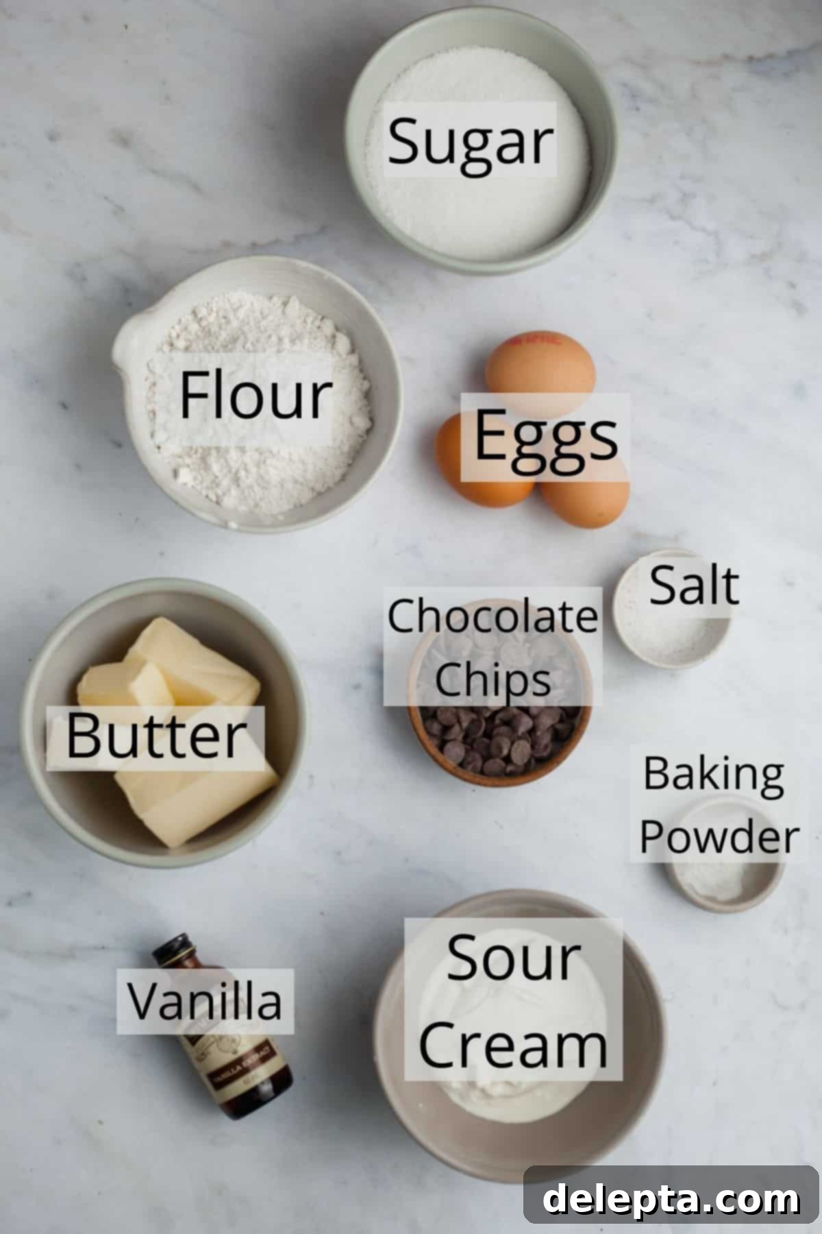 The Ultimate Chocolate Chip Loaf 3 All the essential ingredients for making a delicious chocolate chip loaf cake, carefully weighed and portioned into small glass bowls, ready for baking.