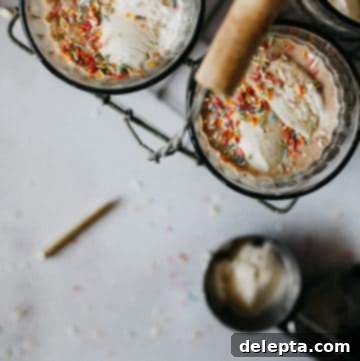 Frosty Funfetti Shakes 5 bird's eye view of two milkshakes in glasses, with a spoon and ice cream scoop on the side