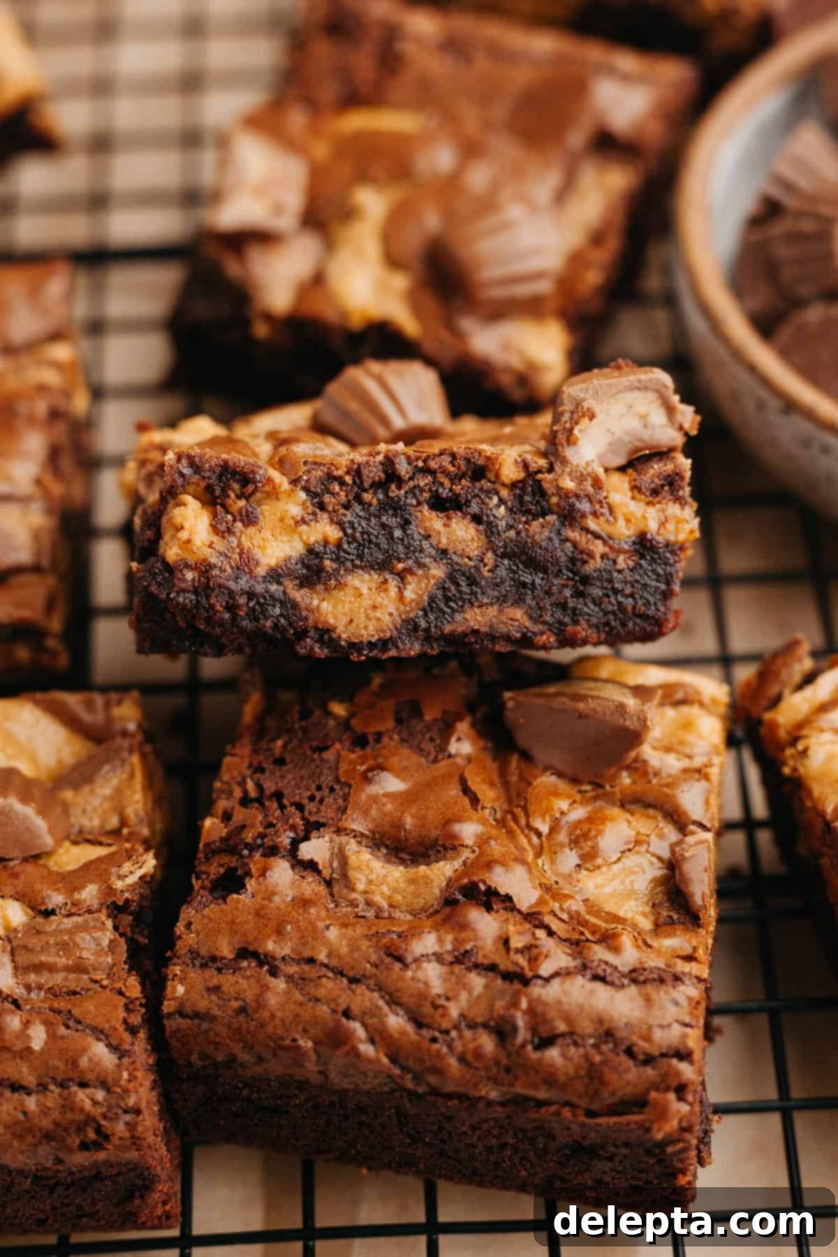 Peanut Butter Cup Brownie Bliss 7 Freshly baked peanut butter cup brownies cooling on a wire rack, ready to be sliced.