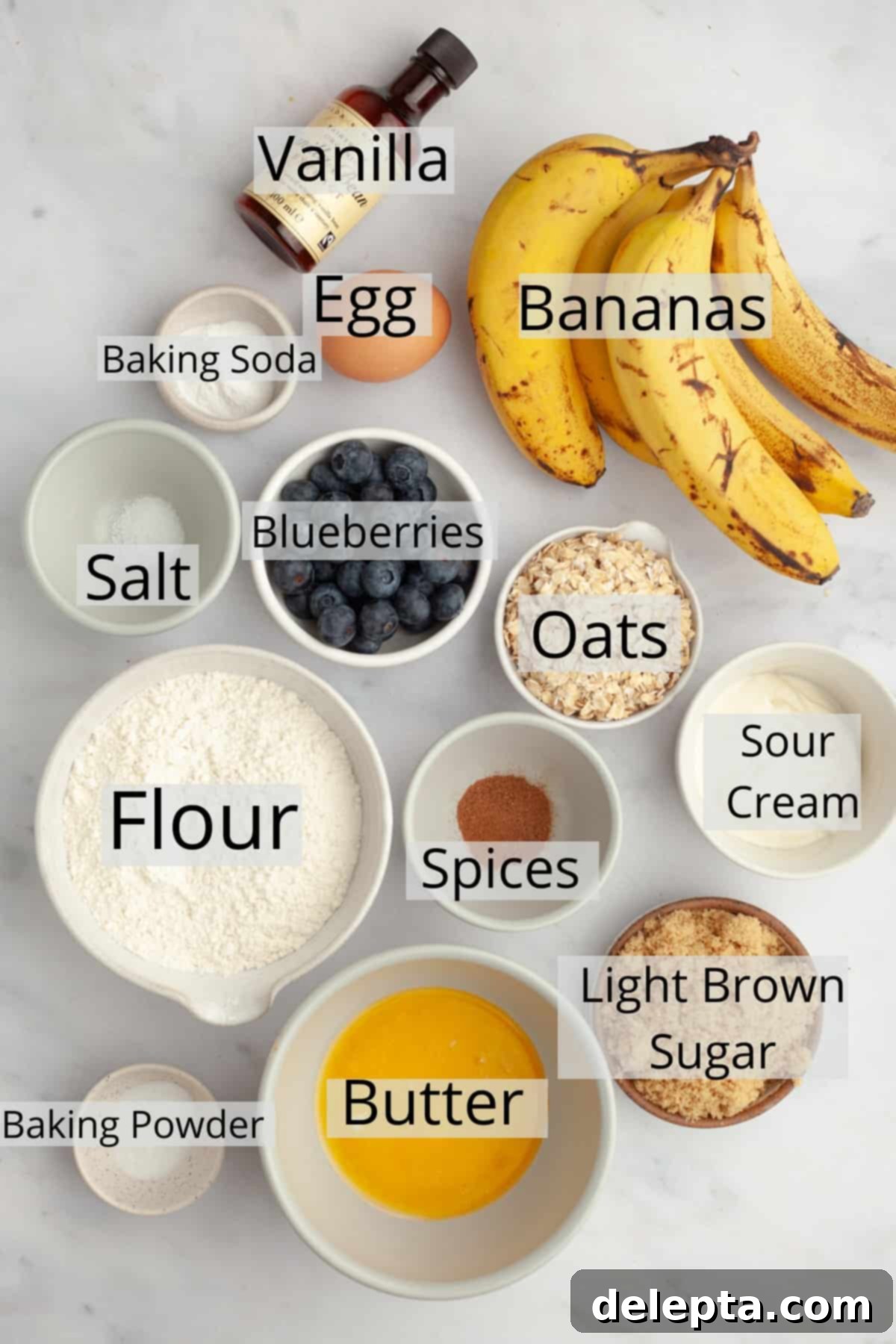 Golden Banana Berry Oatmeal Muffins 3 All the ingredients needed to make oatmeal banana blueberry muffins, weighed out into small bowls, ready for baking.