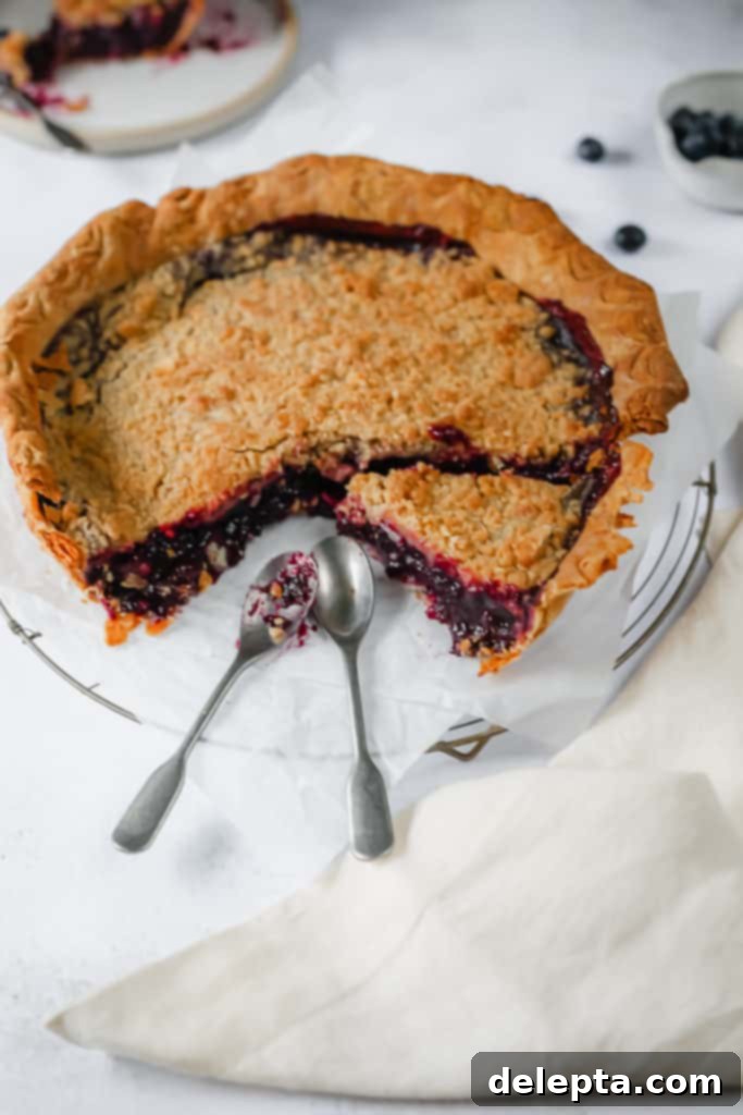 Wild Blueberry Bliss with Cream Cheese Crust 4 blueberry pie with a slice ready, and two spoons