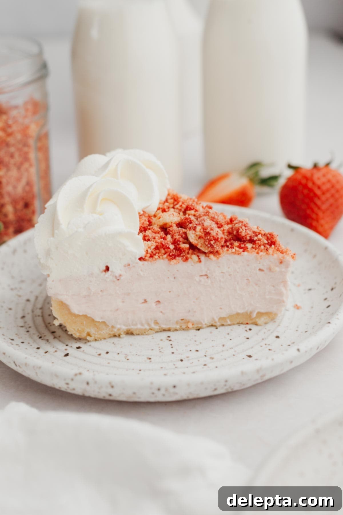 Divine No-Bake Strawberry Crunch Cheesecake 11 A delicious slice of strawberry crunch cheesecake neatly plated, ready to be enjoyed, showing off its crisp crust and creamy filling.