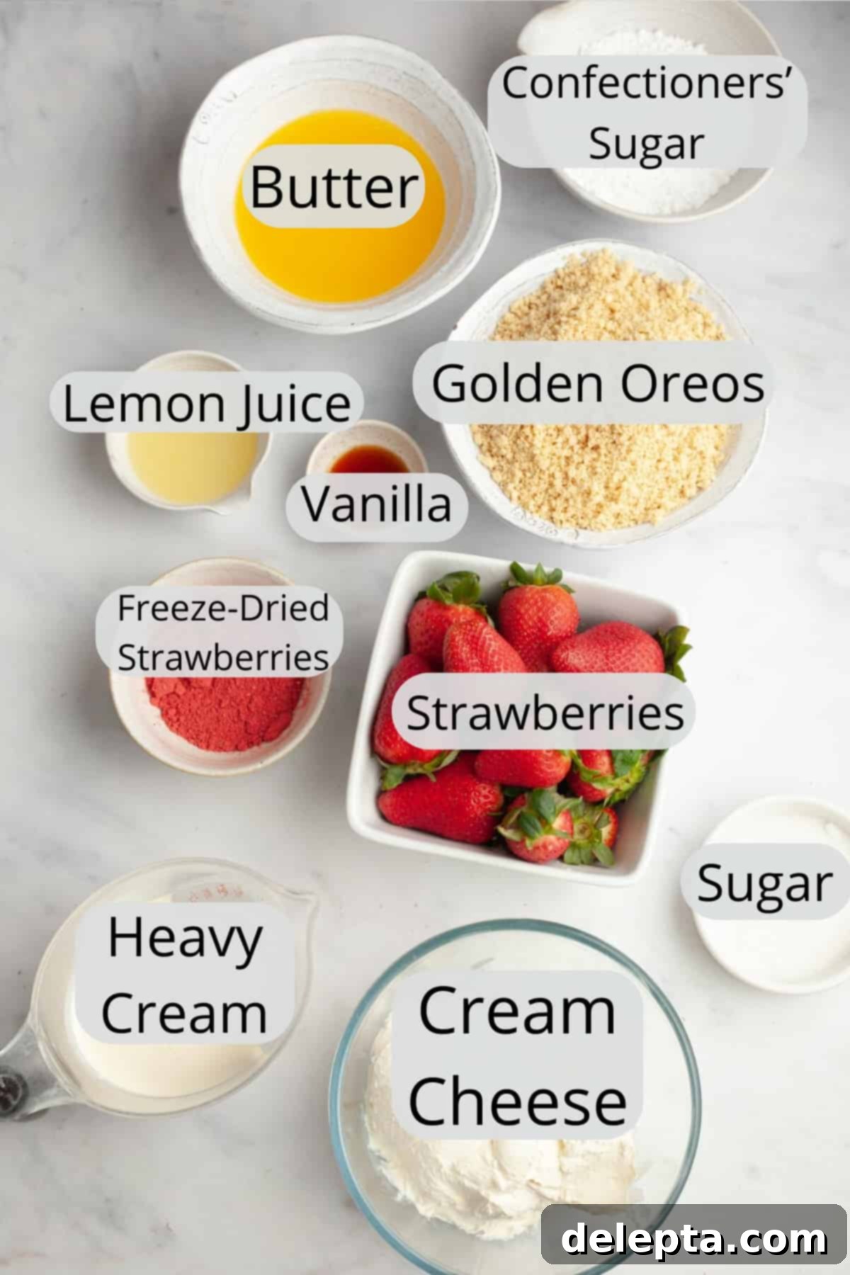 Divine No-Bake Strawberry Crunch Cheesecake 3 All the necessary ingredients for crafting a strawberry crunch cheesecake, meticulously weighed out and presented in small individual bowls for clarity.
