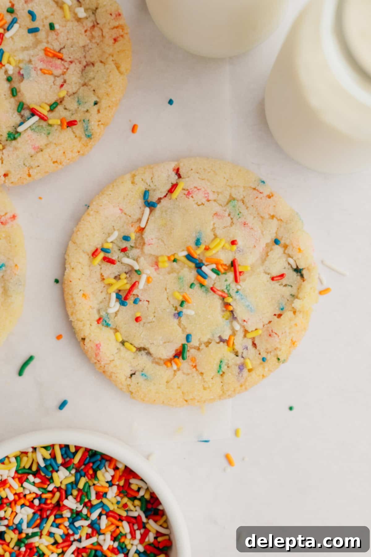 Pillowy Soft Rainbow Sugar Cookies 2 A close up of a sugar sprinkle cookie, showcasing its soft texture and colorful sprinkles.