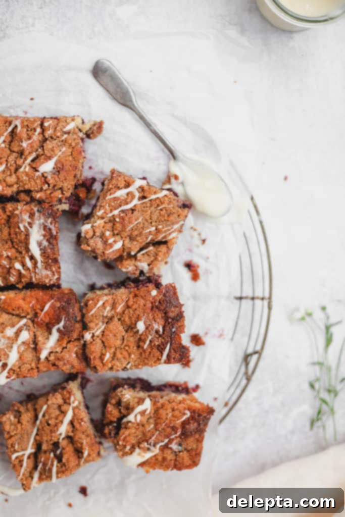 Blackberry Streusel Buckle with Cream Cheese Drizzle 3 Bird's eye view of a tray of freshly baked blackberry buckle bars, with a crisp streusel topping.