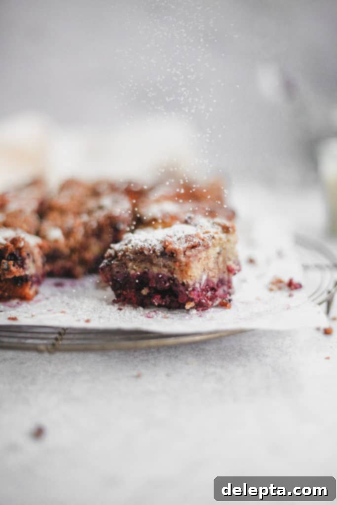 Blackberry Streusel Buckle with Cream Cheese Drizzle 7 A single blackberry buckle bar, beautifully drizzled with cream cheese glaze and a light dusting of icing sugar.
