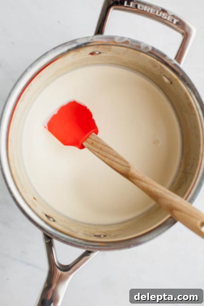 Chocolate-Stuffed Brioche Bliss 15 heavy cream in a silver saucepan