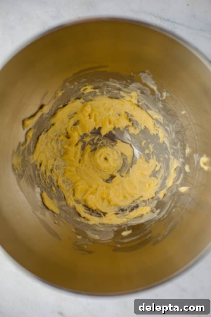 Sea Salt Caramel Macarons 15 A silver mixing bowl with softened unsalted butter being creamed to a smooth consistency for the buttercream.
