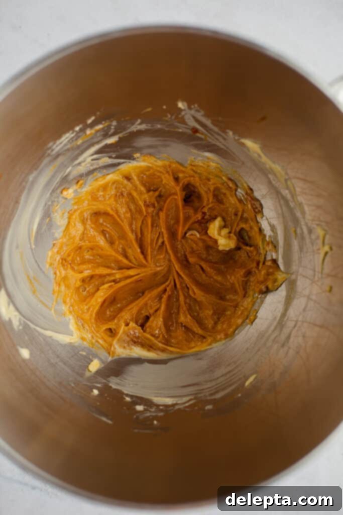 Sea Salt Caramel Macarons 16 A silver mixing bowl containing creamy salted caramel buttercream, perfectly whipped and ready for piping.