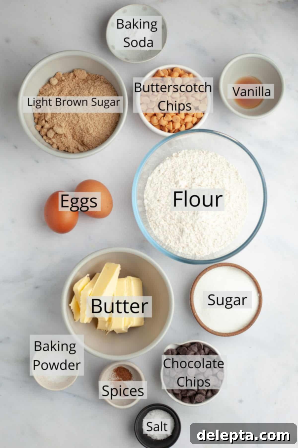 Golden Butterscotch Chocolate Chip Delights 3 All the necessary ingredients for making butterscotch chocolate chip cookies are neatly arranged in small bowls, ready for use.