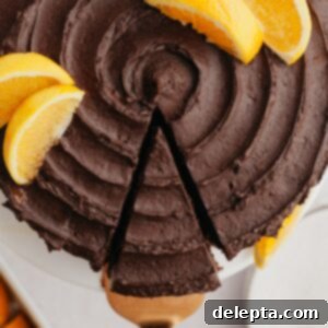 Zesty Chocolate Orange Cake 10 An overhead shot of a slice of chocolate orange cake being removed from the cake.