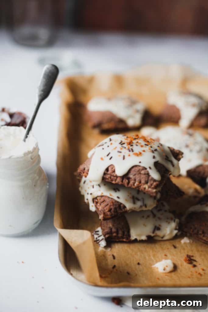 S'mores Pop Tarts with Gooey Marshmallow Glaze 2 stack of pop tarts next to fluff