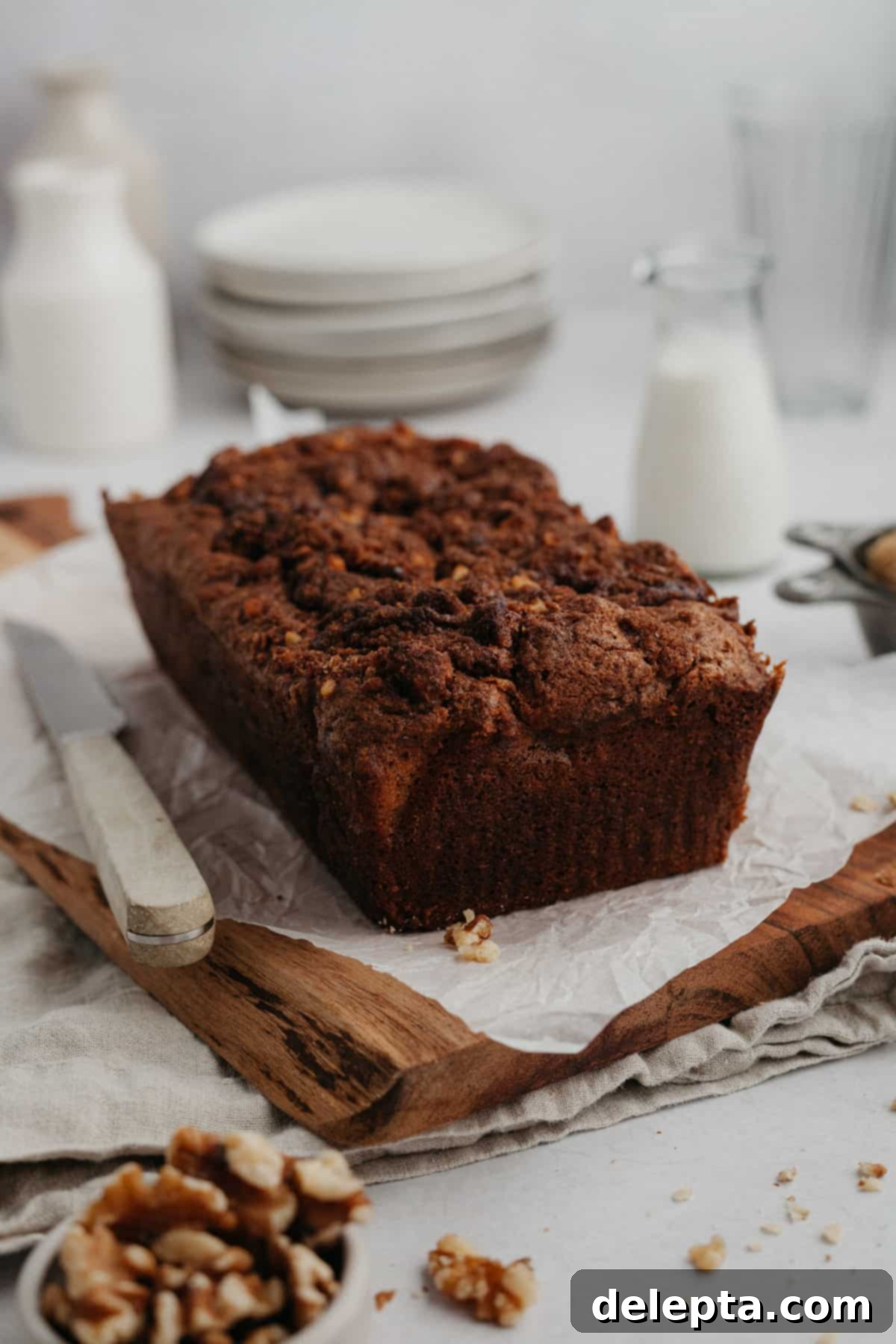 Cinnamon Crumble Banana Bread 2 Cinnamon crunch banana bread loaf on a wooden board, showcasing its golden crust and crunchy topping