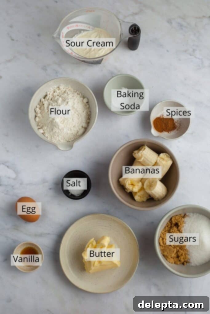 Cinnamon Crumble Banana Bread 4 Overhead shot of cinnamon crunch banana bread ingredients, including ripe bananas, flour, spices, butter, sugars, egg, vanilla, and sour cream