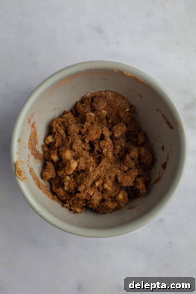 Cinnamon Crumble Banana Bread 6 A small grey bowl filled with prepared cinnamon crunch topping, showcasing its crumbly texture