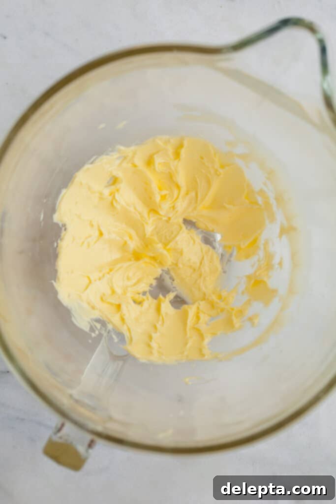 Cinnamon Crumble Banana Bread 8 Creamed unsalted butter in a clear glass mixing bowl, looking smooth and pale