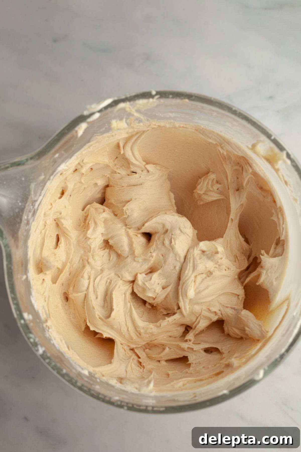 Effortlessly Moist Mocha Cupcakes with Espresso Buttercream 9 Coffee buttercream in a large glass bowl.