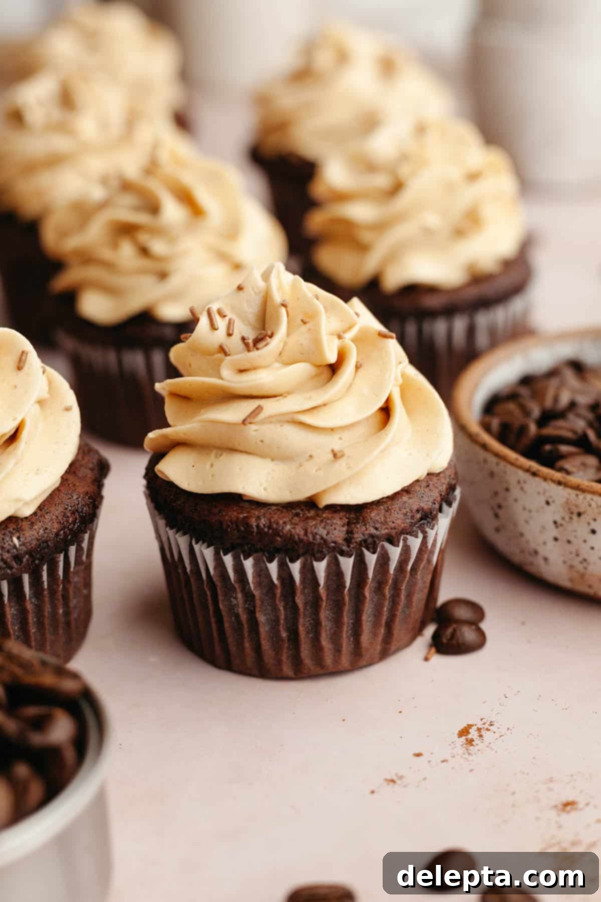 Effortlessly Moist Mocha Cupcakes with Espresso Buttercream 10 Chocolate cupcakes covered in a light brown frosting.