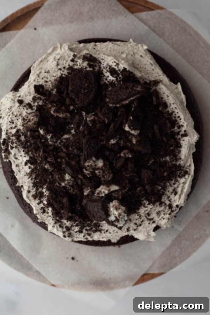 Decadent Oreo Drip Cake 15 A chocolate cake frosted with Oreo buttercream and crushed Oreos on top of the first layer