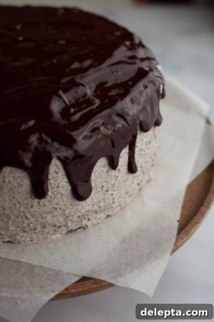 Decadent Oreo Drip Cake 16 A close-up of an Oreo cake with a chocolate drip cascading down its sides