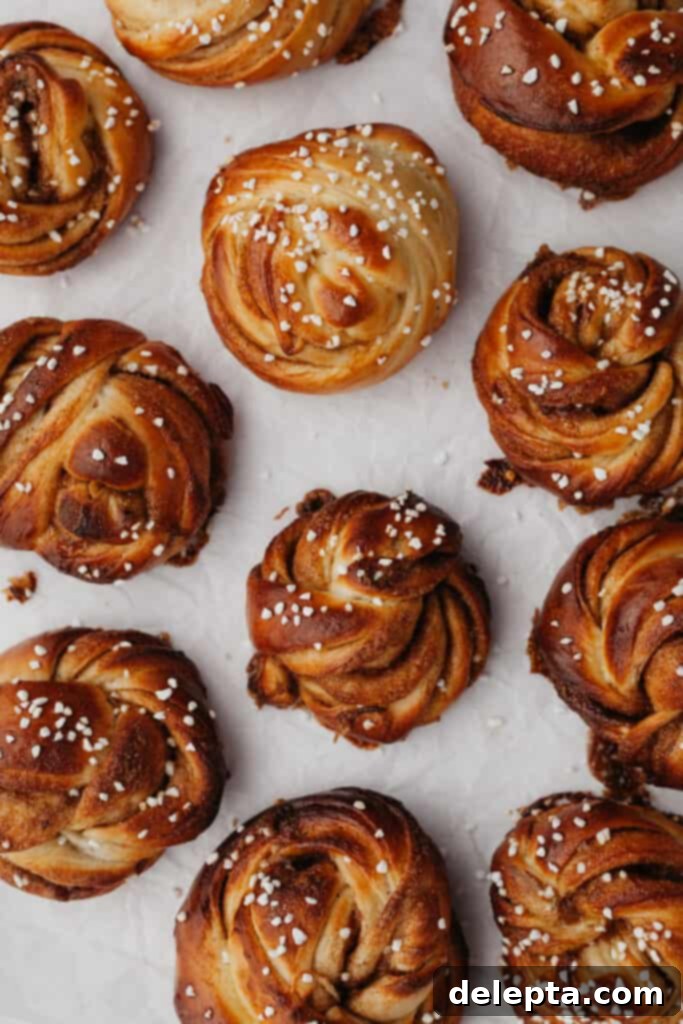Pillowy Swedish Cinnamon Swirls 17 A tray of beautifully baked Swedish cinnamon buns, golden brown and glistening with melted pearl sugar, ready to be served.