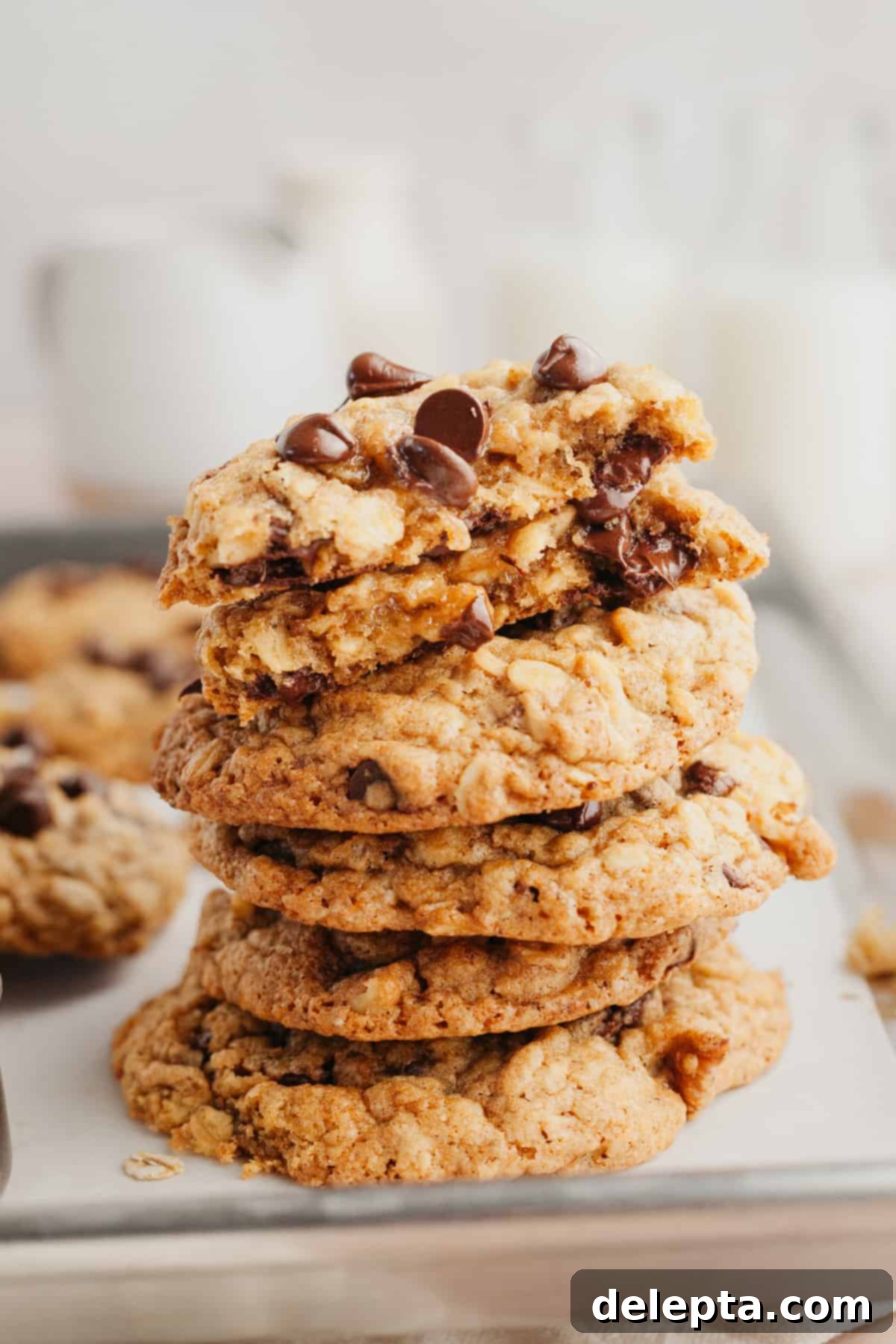 Irresistible Oatmeal Walnut Chocolate Chip Cookies 7 A stack of golden-brown oatmeal chocolate chip cookies, showing their soft centers and crisp edges, inviting a bite.