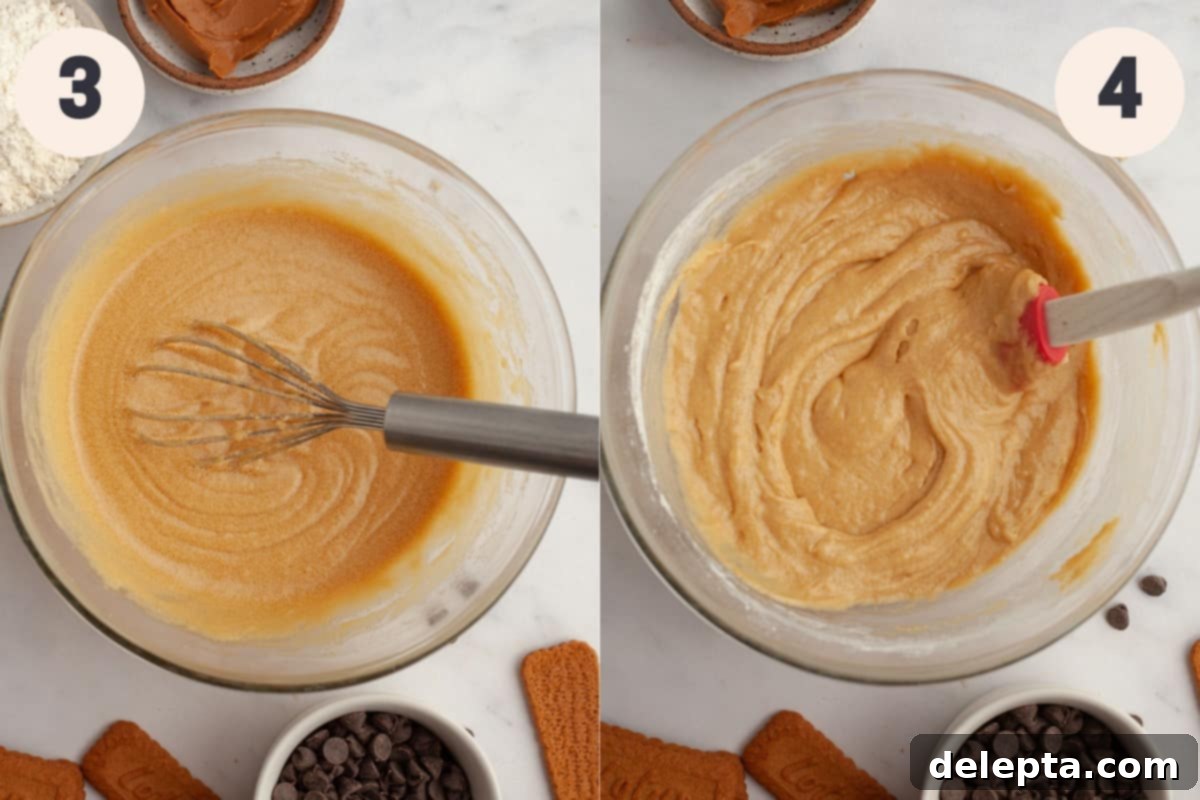 Easy One Bowl Brown Butter Biscoff Blondies 5 A glass mixing bowl filled with smooth, light brown blondie batter after wet ingredients have been incorporated.