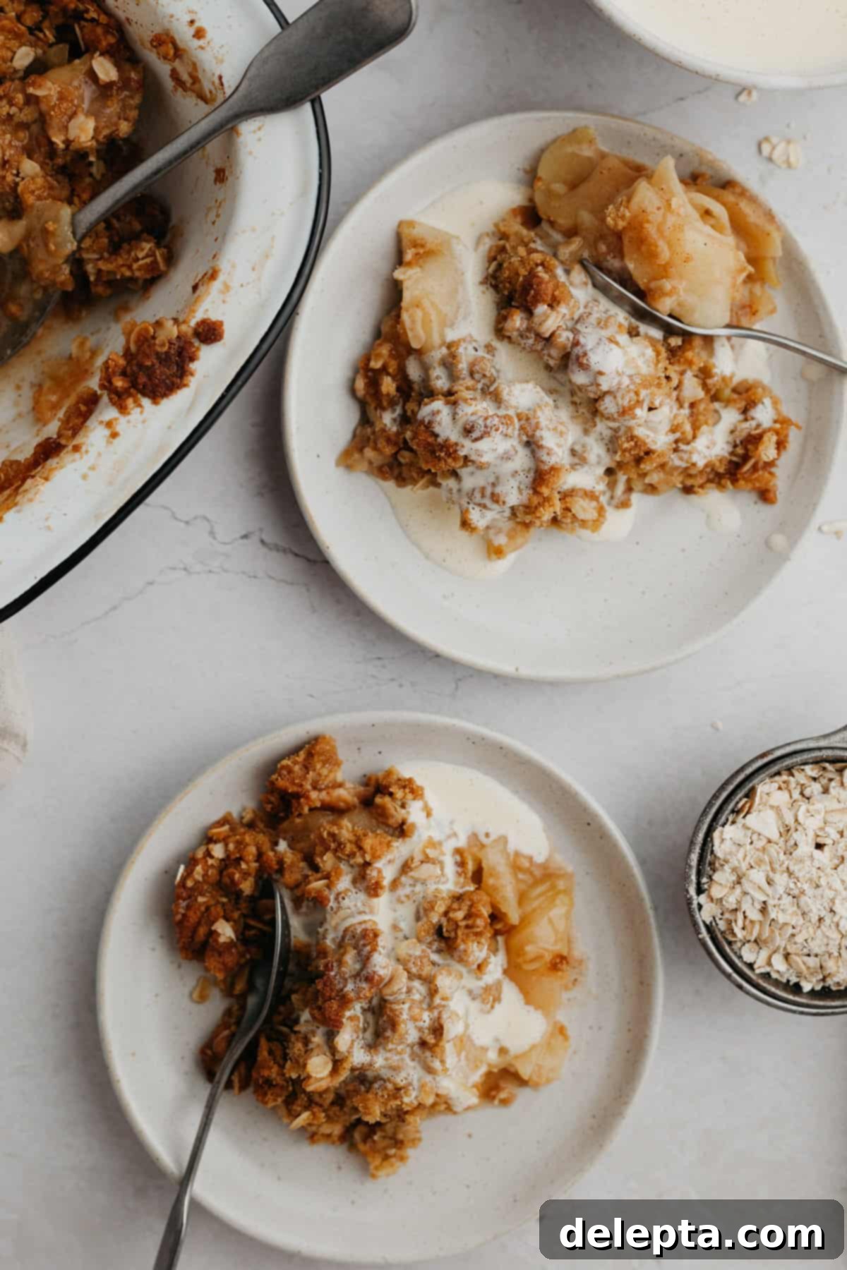 Warm Apple Crumble with Custard 10 Two plates with apple crumble, covered in vanilla custard