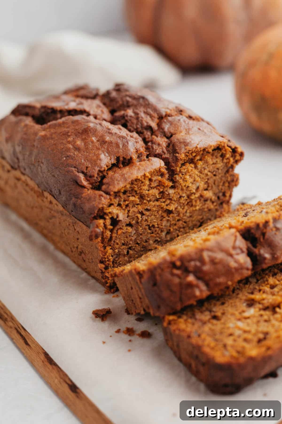 Effortless Pumpkin Carrot Banana Bread 2 A beautifully sliced healthy pumpkin banana bread, showcasing its moist texture and rich autumnal colors.