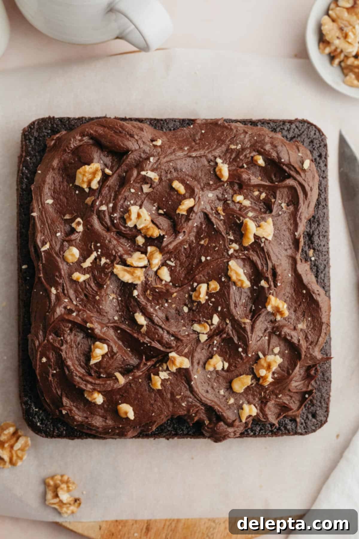 Simply Divine Moist Chocolate Walnut Cake 10 A square chocolate walnut cake, beautifully frosted with dark chocolate sour cream buttercream and garnished with chopped walnuts.