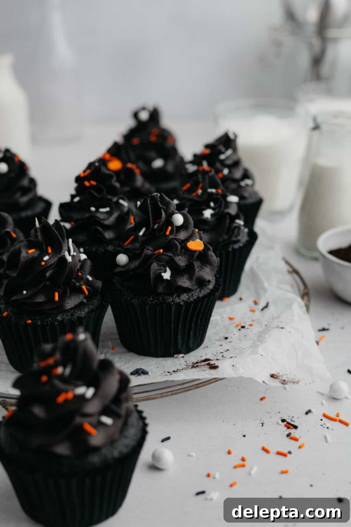 Midnight Velvet Delights 8 A beautifully arranged plate of frosted black velvet cupcakes.