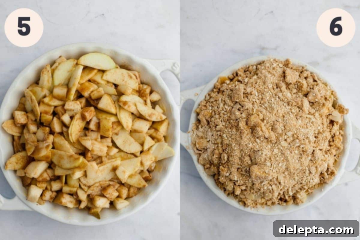 Ginger-Kissed Harvest Apple & Pear Crisp 7 A white ceramic baking dish filled with the spiced pear and apple mixture, then covered with the crumbly oat topping, ready for baking.
