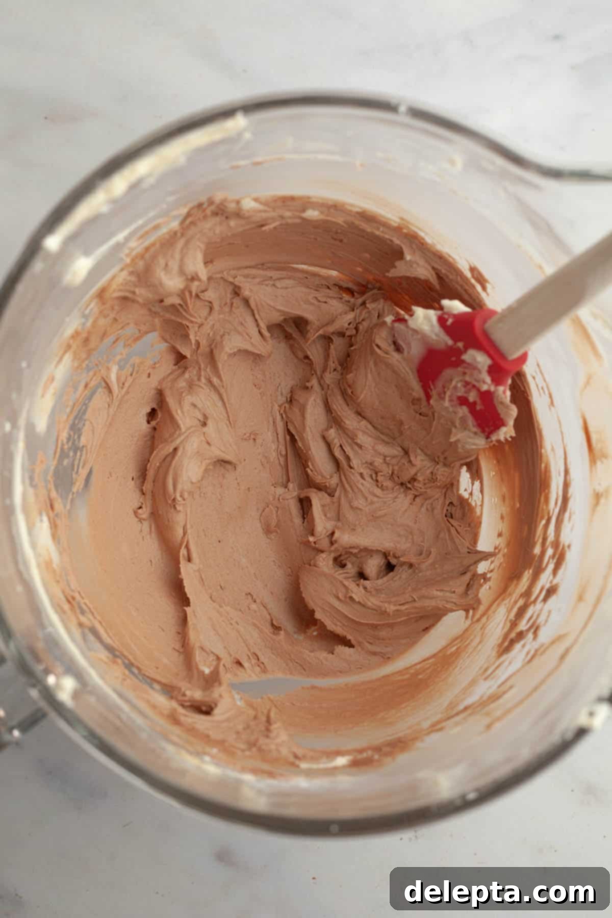 Quick Nutella-Stuffed Cupcakes 9 Nutella frosting in a large glass bowl.