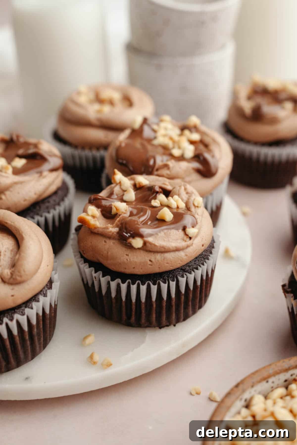 Quick Nutella-Stuffed Cupcakes 10 Chocolate cupcakes with chocolate frosting and chopped hazelnuts.