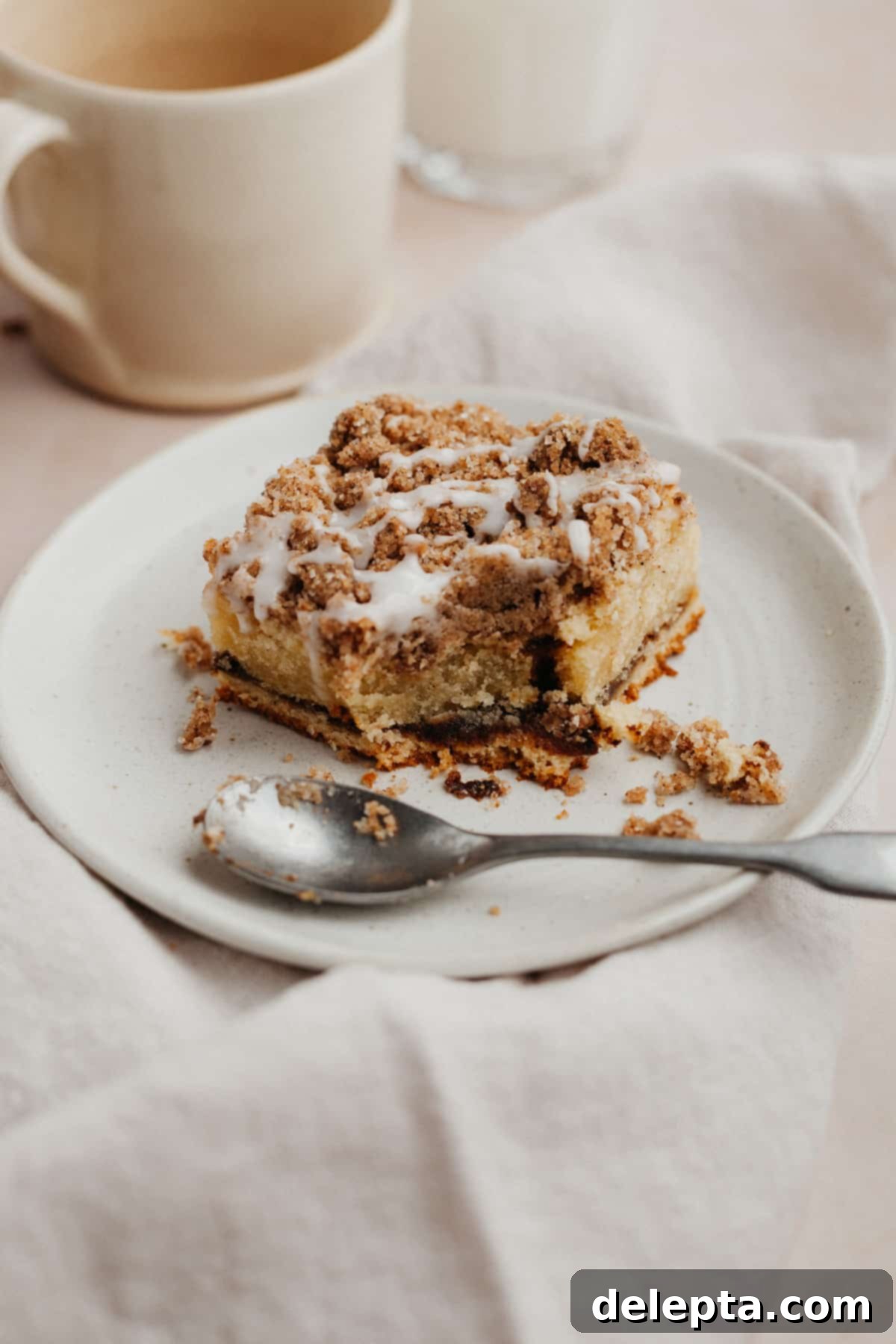 Espresso-Spiked Chai Coffee Cake 2 a square slice of chai coffee cake on a small beige plate
