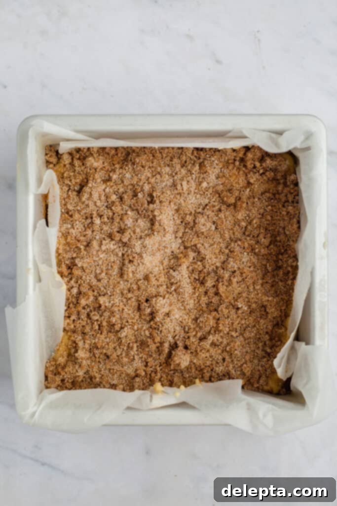 Espresso-Spiked Chai Coffee Cake 14 A square baking pan with cake batter and cinnamon filling