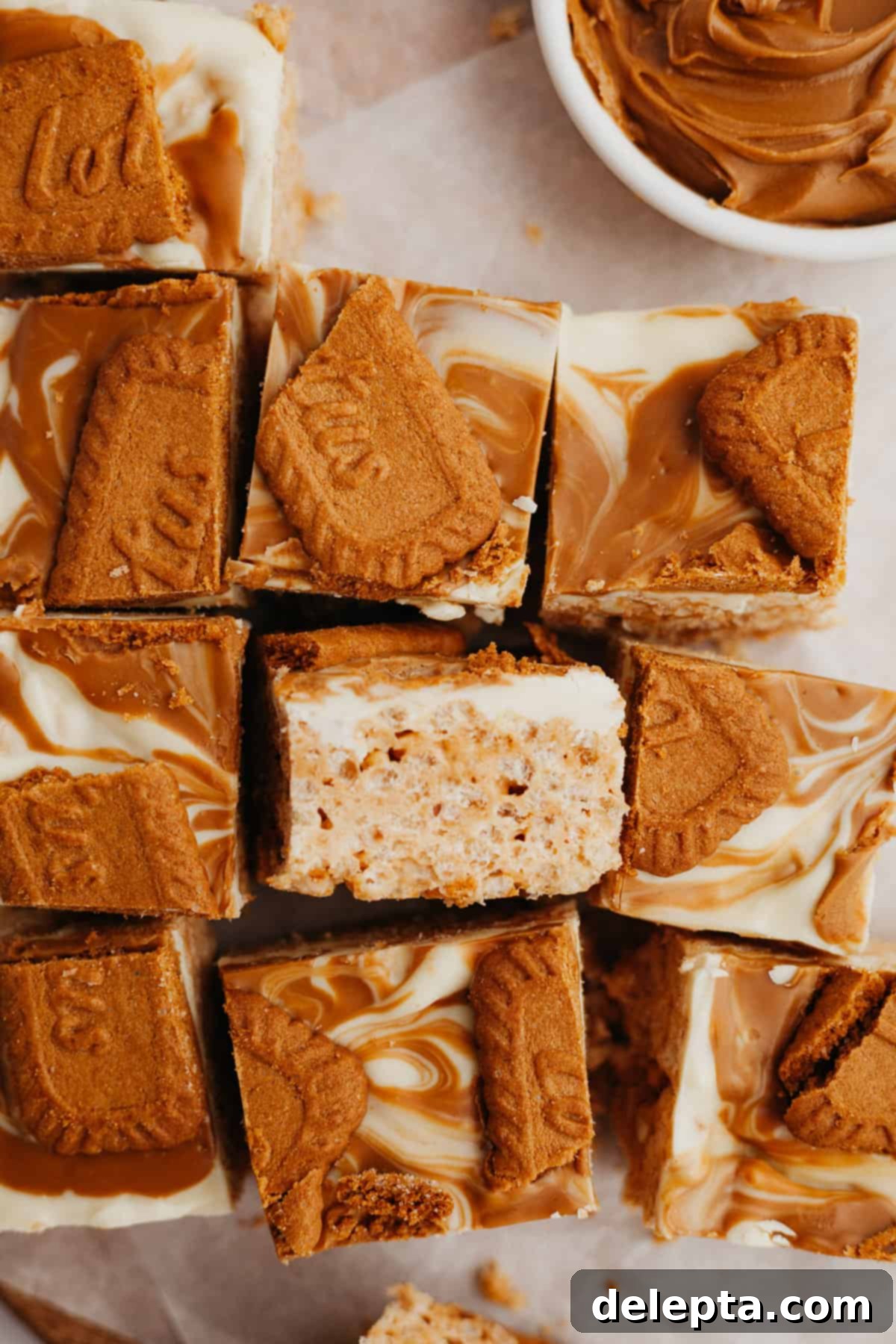 Ultimate Biscoff Krispie Bars 8 White chocolate covered Biscoff rice krispie treats from above, with one treat on its side showing the layers.