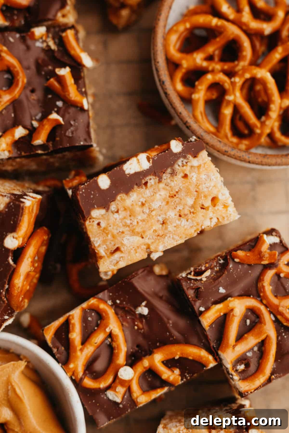 Decadent Chocolate Peanut Butter Rice Krispie Treats 2 Peanut butter chocolate rice krispie treat squares, topped with pretzels.