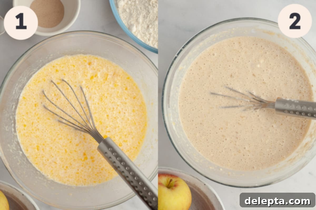 Apple Pie Waffles 4 Waffle batter in a mixing bowl with a whisk, showing a smooth, creamy consistency.