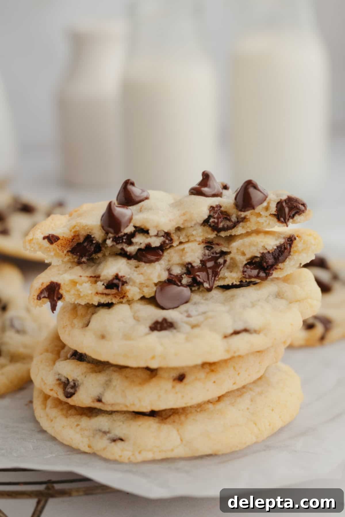 Crispy Golden Chocolate Chip Cookies 2 A stack of golden-brown chocolate chip cookies, baked without brown sugar, showcasing their soft texture and melted chocolate chips.