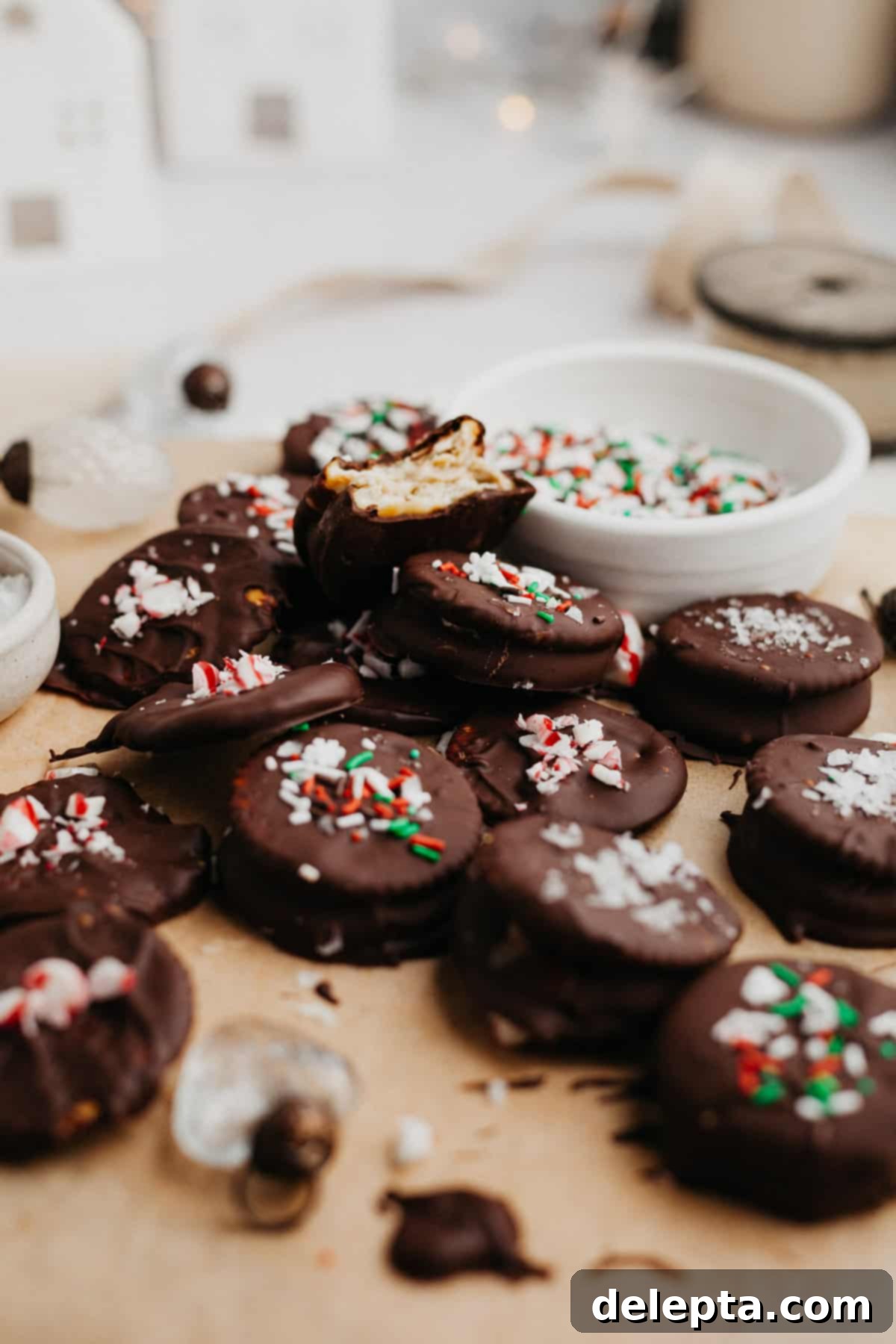 Effortless Holiday No-Bake Treats 8 Chocolate dipped sandwich cookies covered in vibrant Christmas sprinkles, neatly arranged.
