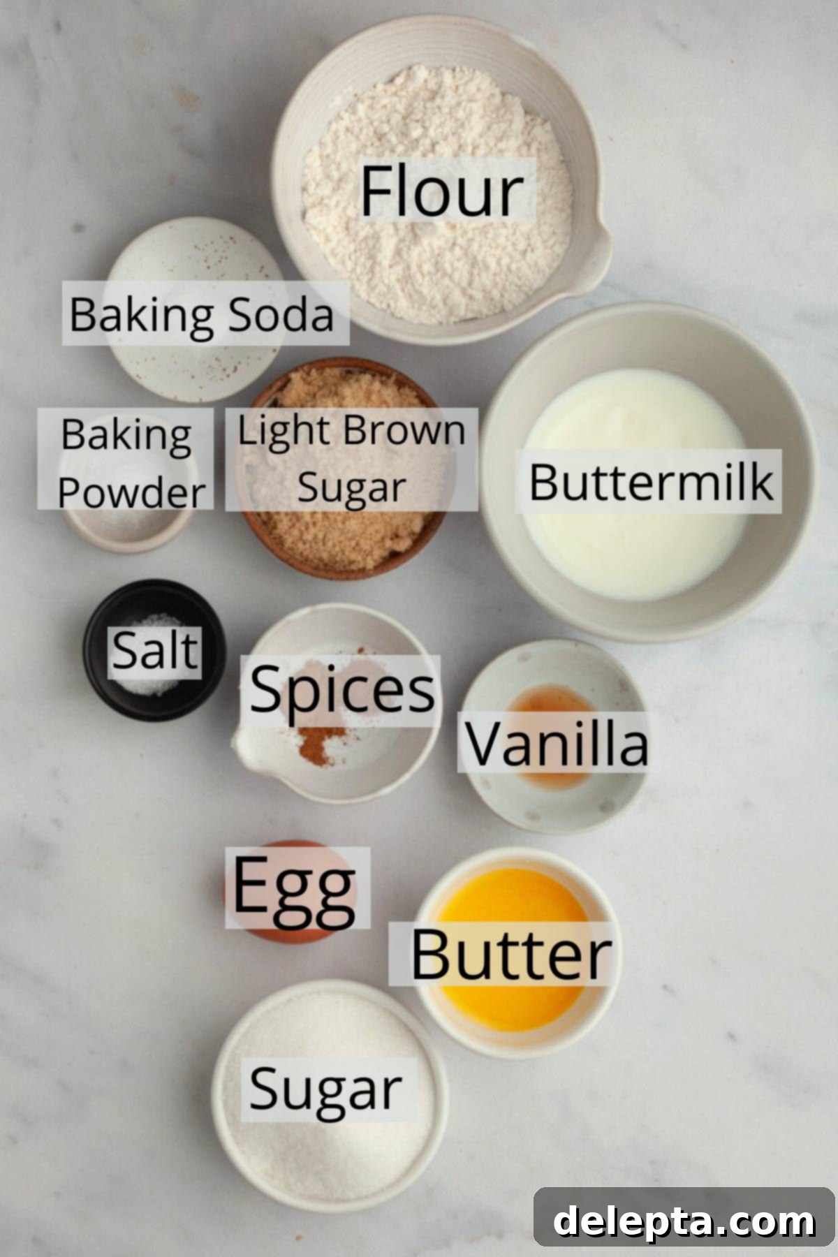 15-Minute Cinnamon Donut Magic 3 All the ingredients needed to make cinnamon donuts, weighed out into small bowls, ready for baking.