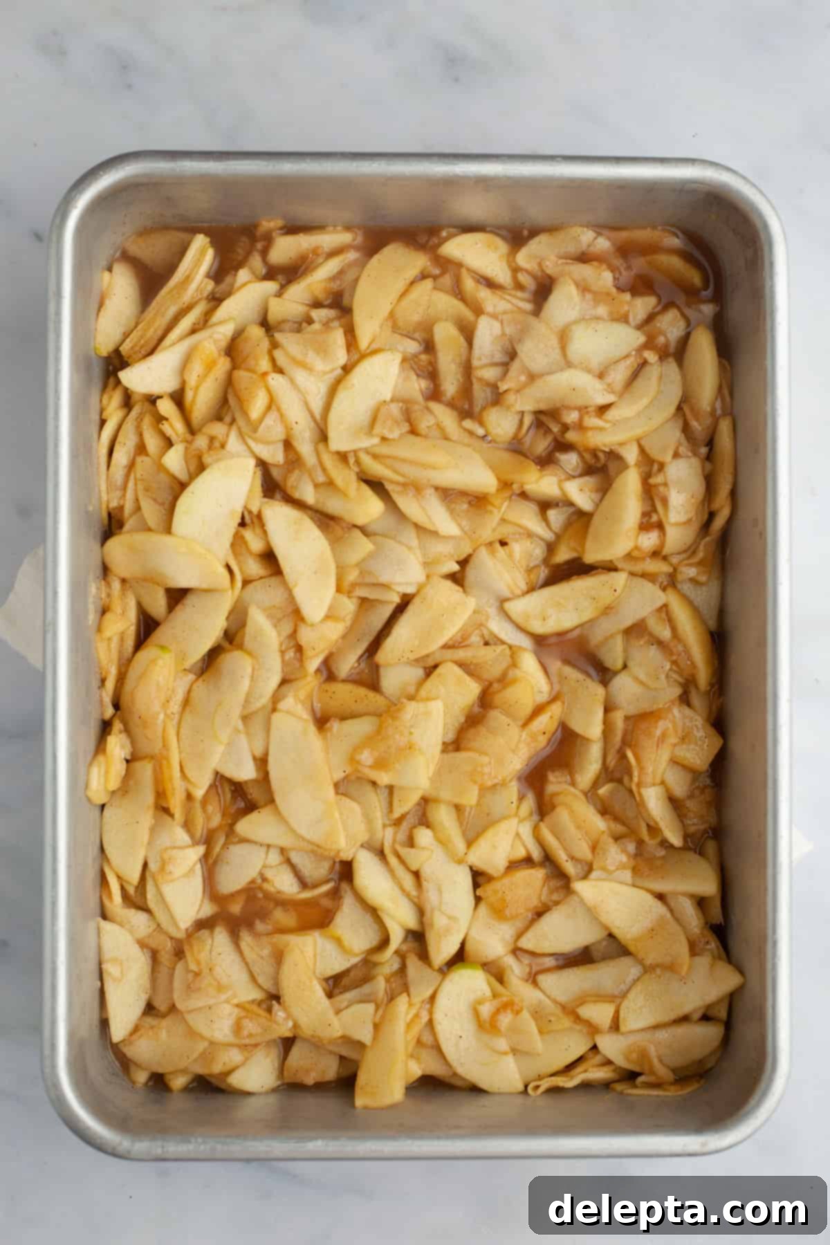 Fireside Bourbon Apple Pie 12 Warm apple pie filling spread evenly in a shallow tray, allowing it to cool down quickly and thoroughly.