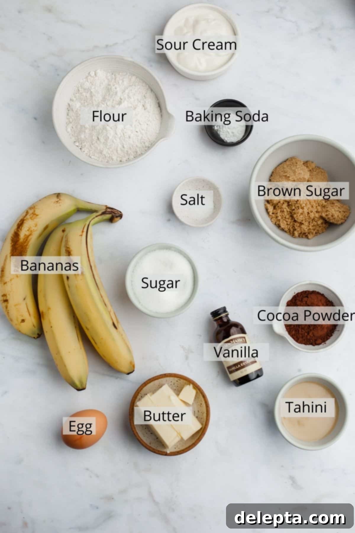 Chocolate-Tahini Swirled Banana Bread with Creamy Tang 3 All the pre-measured ingredients for tahini chocolate banana bread neatly arranged in small bowls, ready for baking.