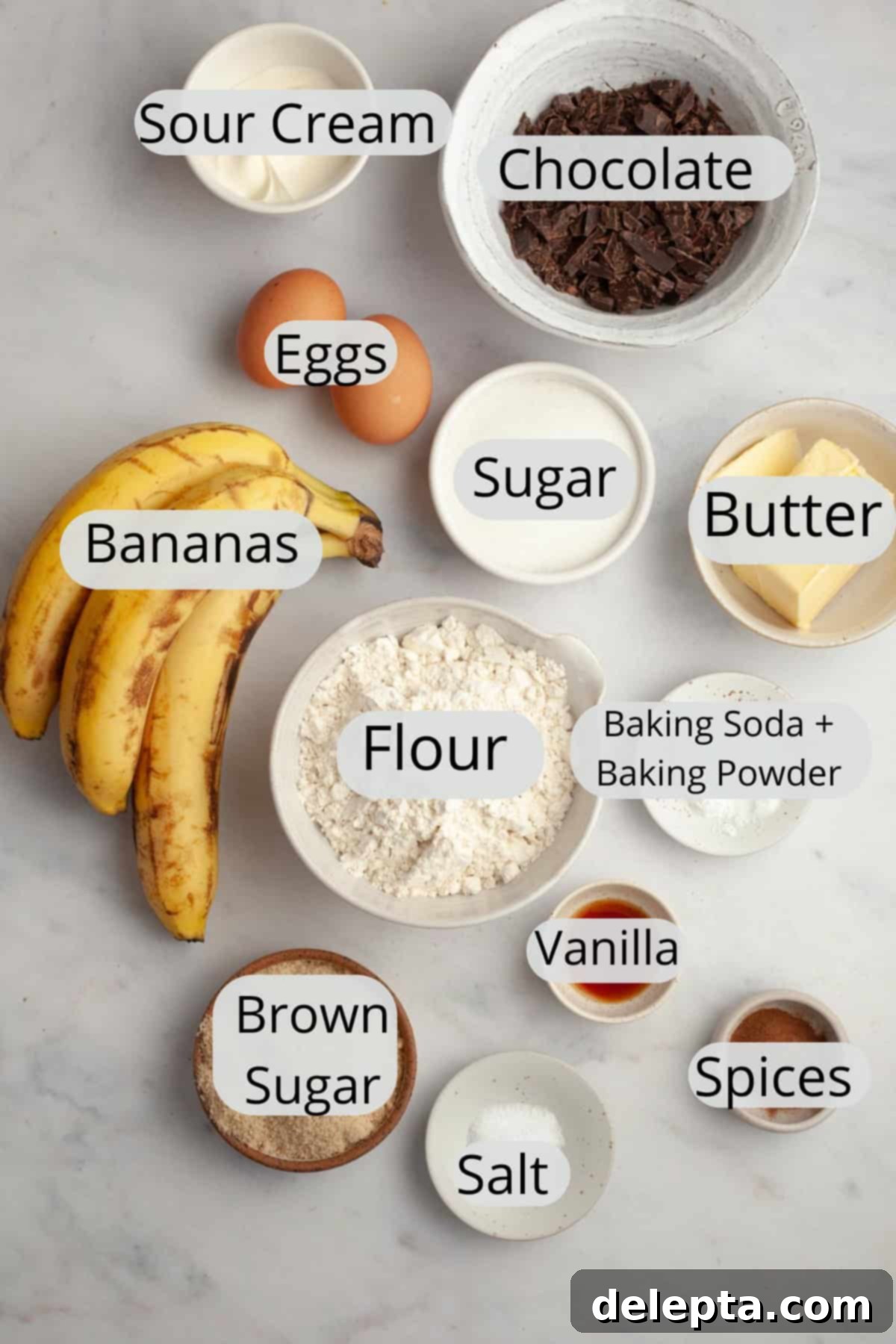 Gourmet Chocolate Chunk Banana Muffins 4 All the necessary ingredients for making chocolate chunk banana muffins, meticulously weighed out and arranged in small bowls, ready for baking.