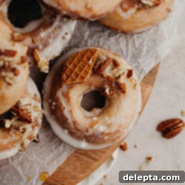 Irresistible Baked Maple Doughnuts 8 Glazed maple doughnuts on a wooden board